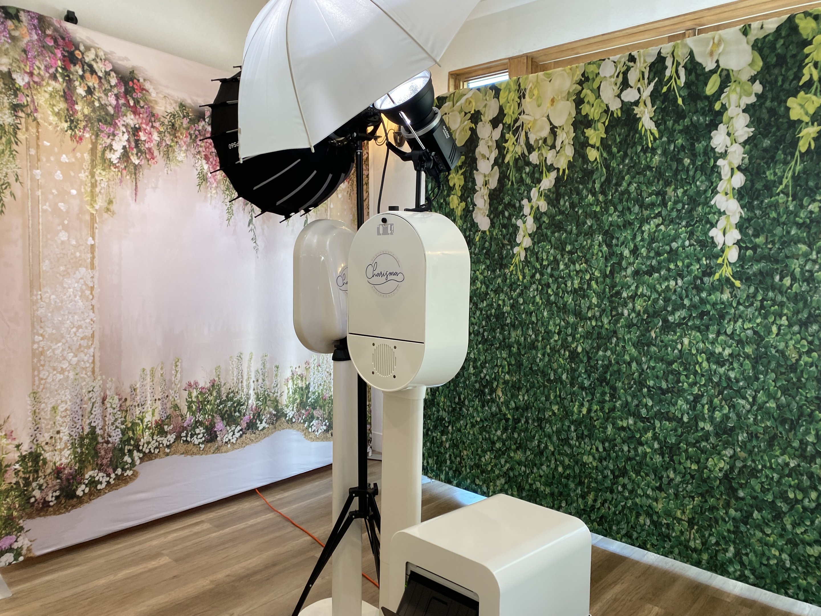 Our photo booth set up beside a greenery and floral wall before guests arrive